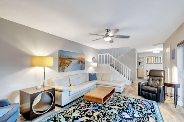 living room with light wood-type flooring and ceiling fan