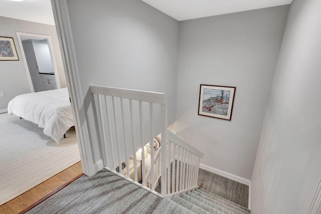 stairs featuring hardwood / wood-style floors