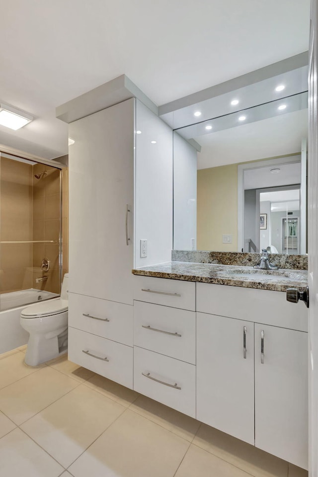 full bathroom featuring tile patterned floors, vanity, tiled shower / bath combo, and toilet