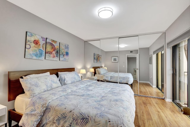 bedroom featuring light hardwood / wood-style flooring and a closet