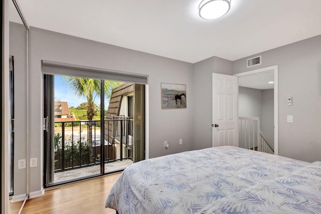 bedroom with access to exterior and light wood-type flooring