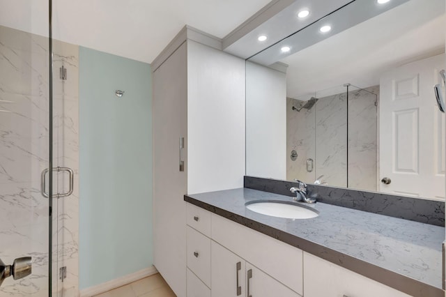 bathroom featuring tile patterned flooring, vanity, and an enclosed shower