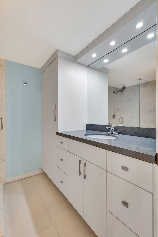 bathroom featuring tile patterned flooring, vanity, and a shower with shower door