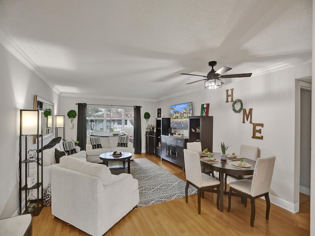 living room featuring a textured ceiling, hardwood / wood-style flooring, ceiling fan, and crown molding