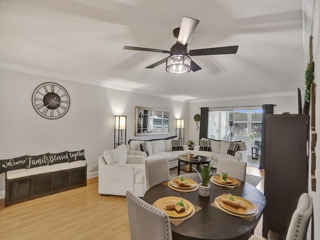 dining area with crown molding, light hardwood / wood-style flooring, ceiling fan, and a textured ceiling