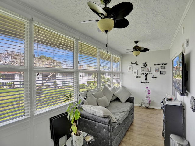 sunroom featuring ceiling fan