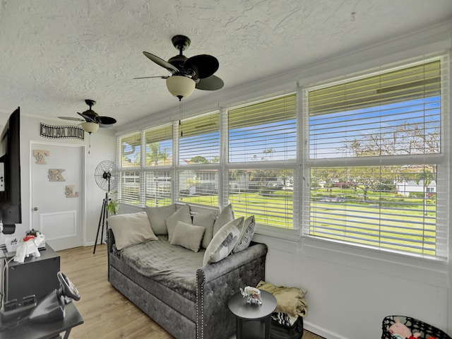 sunroom / solarium with ceiling fan and a wealth of natural light