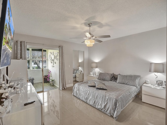 bedroom with ceiling fan, a textured ceiling, and a closet