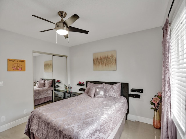 bedroom with ceiling fan and a closet