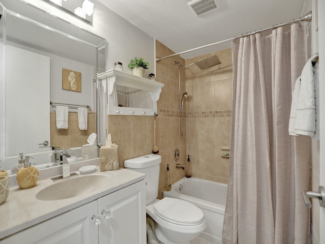 full bathroom with shower / tub combo, vanity, and toilet