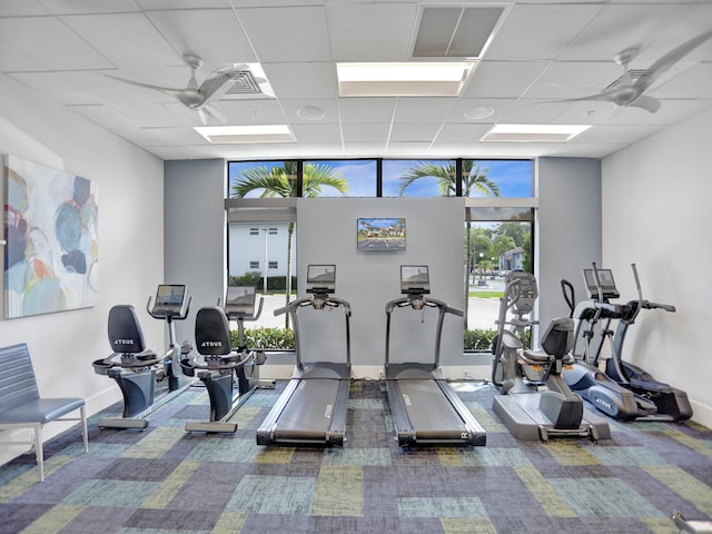 workout area with dark colored carpet, a wealth of natural light, and ceiling fan