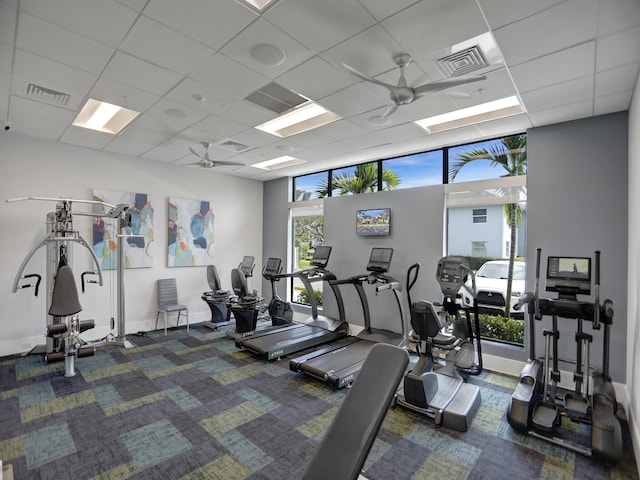 gym featuring a paneled ceiling and ceiling fan