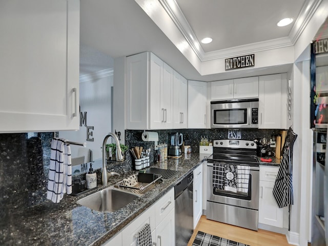 kitchen featuring white cabinets, dark stone countertops, sink, and appliances with stainless steel finishes