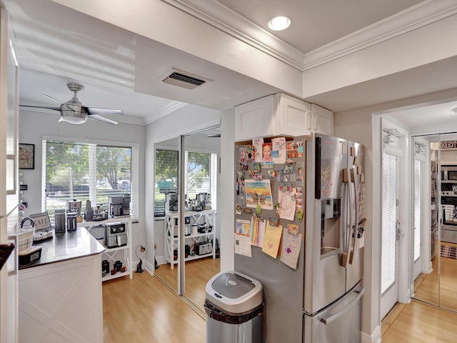 kitchen featuring ceiling fan, light wood-type flooring, white cabinetry, and stainless steel appliances