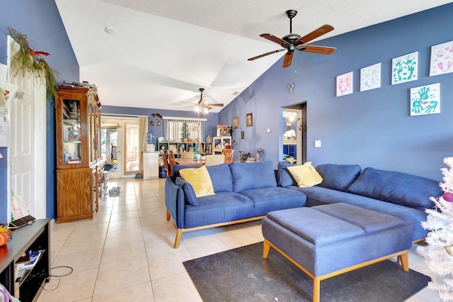 tiled living room featuring ceiling fan and lofted ceiling