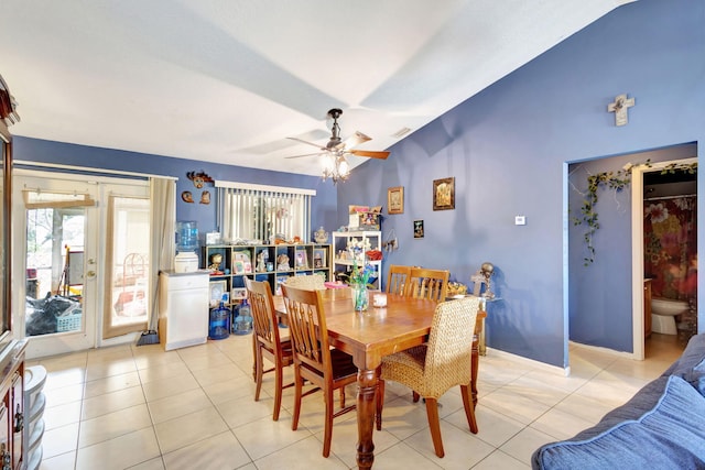 dining space with ceiling fan, lofted ceiling, and light tile patterned flooring