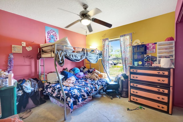 bedroom featuring ceiling fan, a textured ceiling, and concrete floors