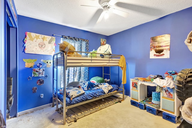 bedroom with ceiling fan and a textured ceiling