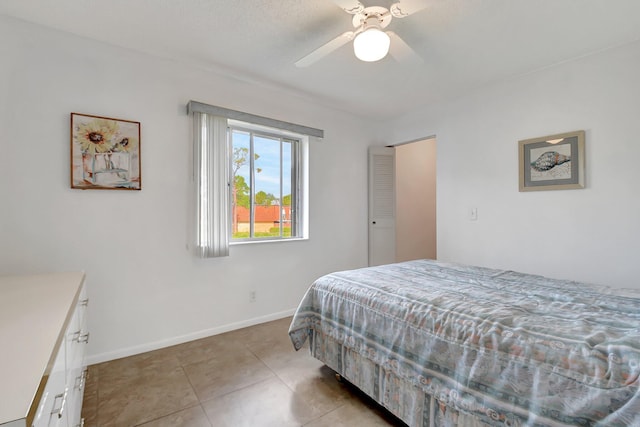 bedroom featuring ceiling fan and light tile patterned floors