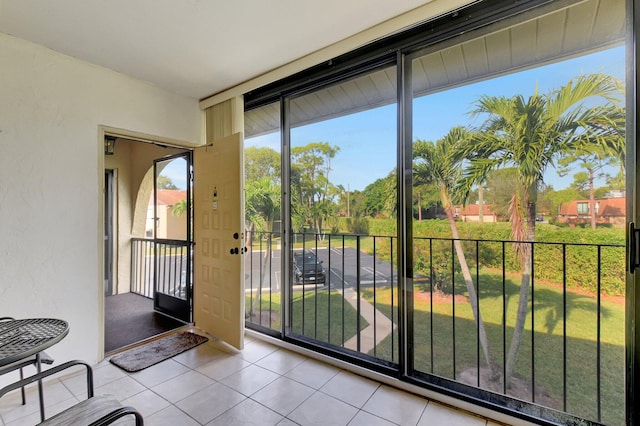 doorway featuring light tile patterned floors and expansive windows