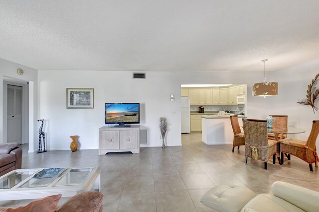 tiled living room with a textured ceiling