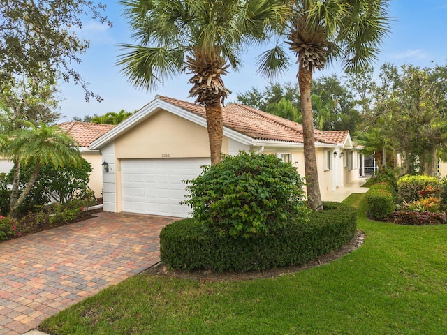 view of front of home with a garage and a front lawn