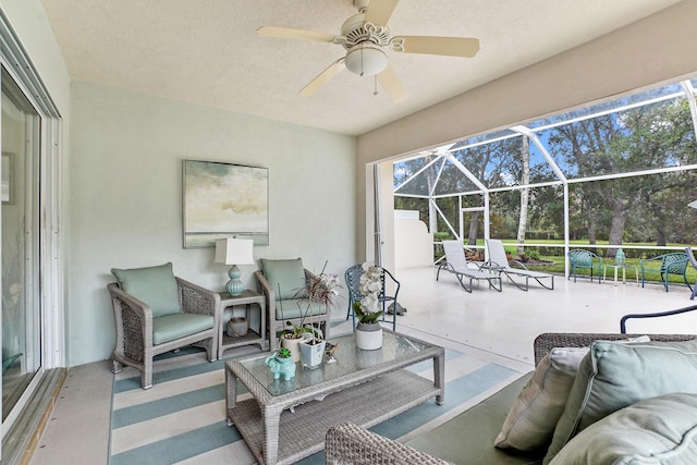 view of patio with an outdoor living space, ceiling fan, and a lanai