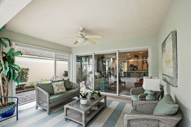 sunroom / solarium featuring ceiling fan