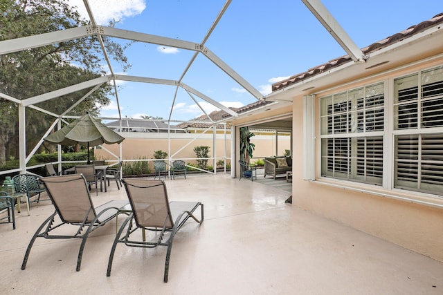 view of patio with glass enclosure