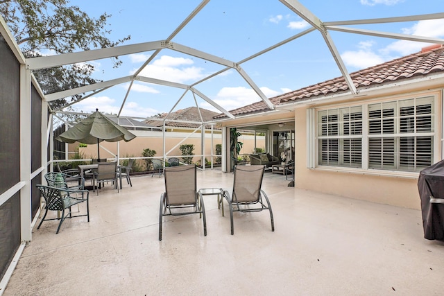 view of patio / terrace featuring a lanai