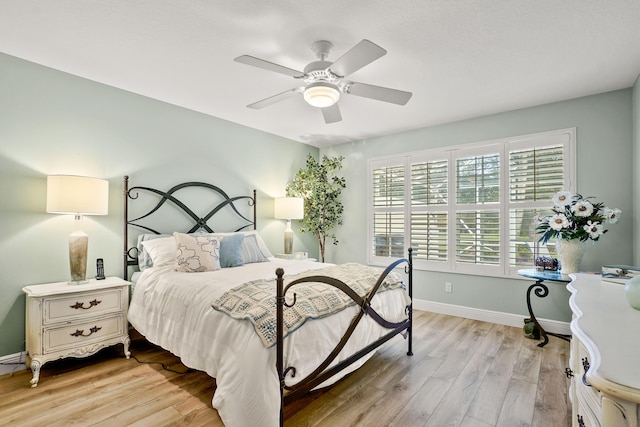 bedroom with ceiling fan and light hardwood / wood-style flooring