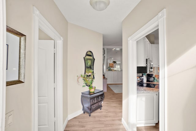 hallway with light wood-type flooring