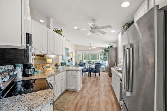 kitchen featuring ceiling fan, kitchen peninsula, light hardwood / wood-style floors, white cabinets, and appliances with stainless steel finishes