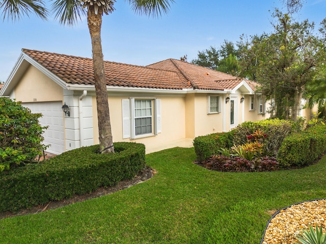 view of property exterior featuring a yard and a garage