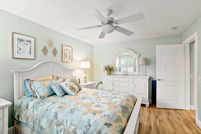 bedroom with ceiling fan and light hardwood / wood-style floors