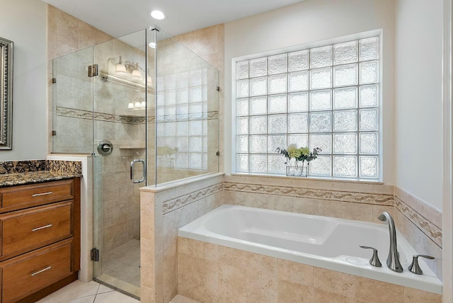 bathroom with tile patterned floors, shower with separate bathtub, and a wealth of natural light