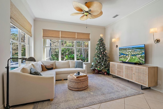 living area featuring light tile patterned floors, ceiling fan, ornamental molding, and visible vents