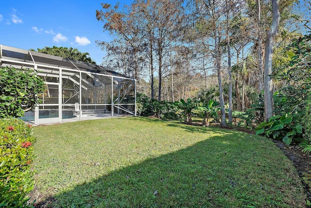 view of yard with glass enclosure, a patio, and a pool