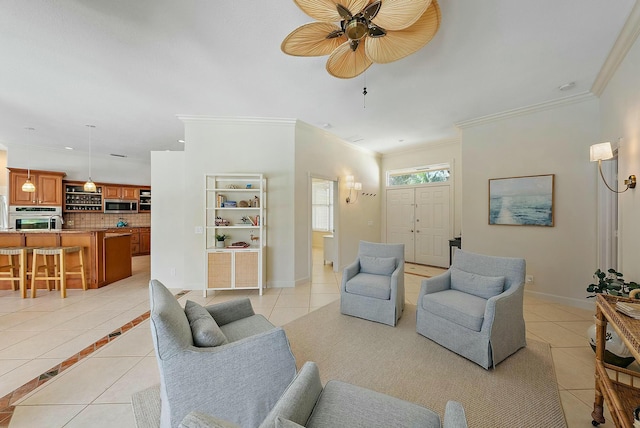 living area with crown molding, baseboards, and light tile patterned floors