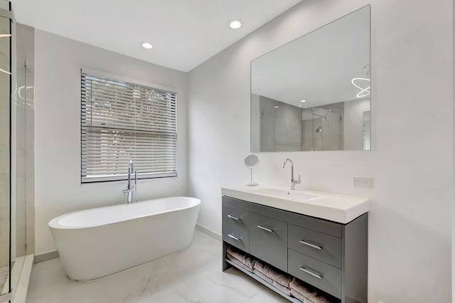 bathroom featuring shower with separate bathtub and vanity