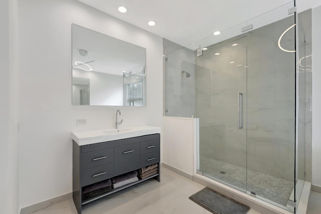 bathroom with vanity and a shower with door