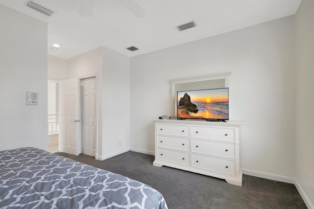 carpeted bedroom with ceiling fan and a closet