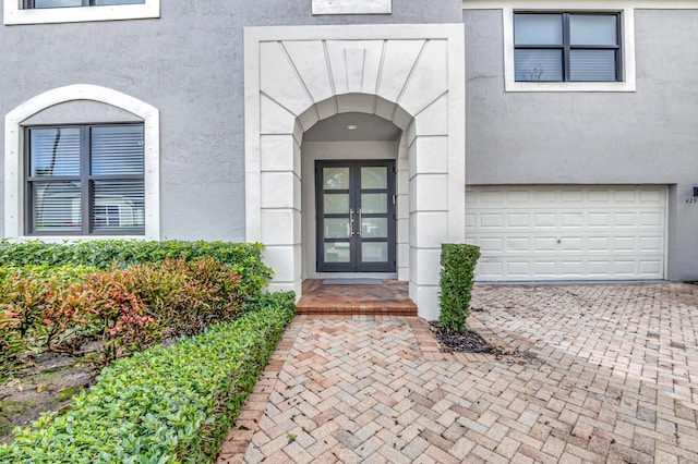 doorway to property with french doors and a garage