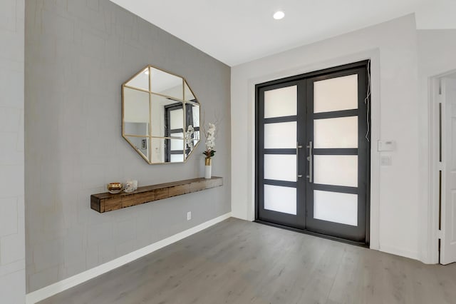 entrance foyer with light hardwood / wood-style floors and french doors