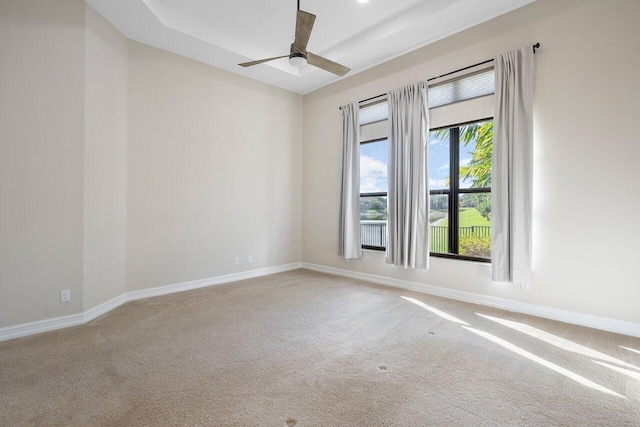 carpeted spare room with ceiling fan