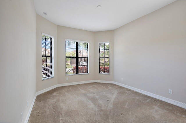 unfurnished room with light carpet