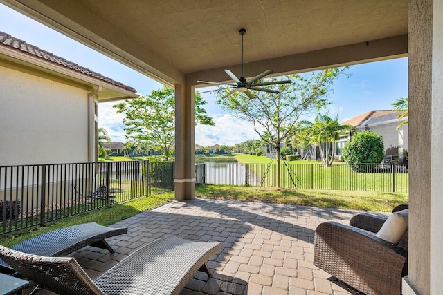 view of patio / terrace with a water view and ceiling fan