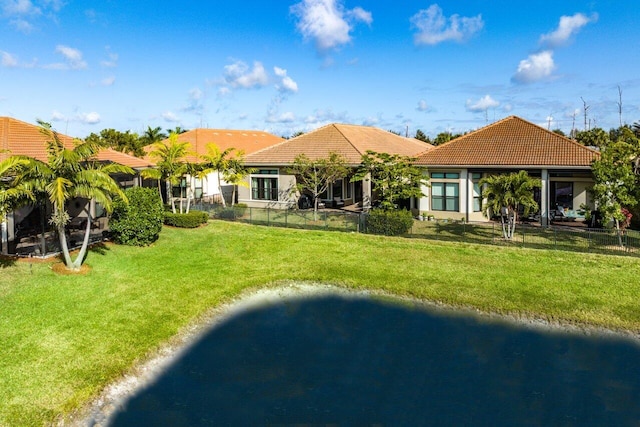 rear view of property featuring a yard