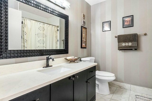 bathroom featuring vanity and toilet