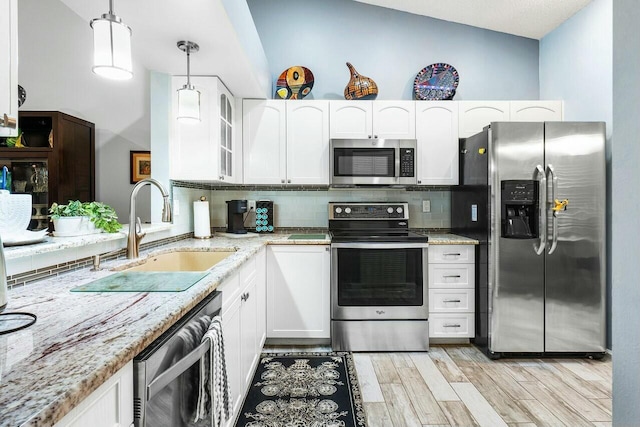 9904 Summerbrook Ter Unit C, Boynton Beach, FL 33437 - kitchen with appliances with stainless steel finishes, a sink, white cabinetry, and light stone countertops